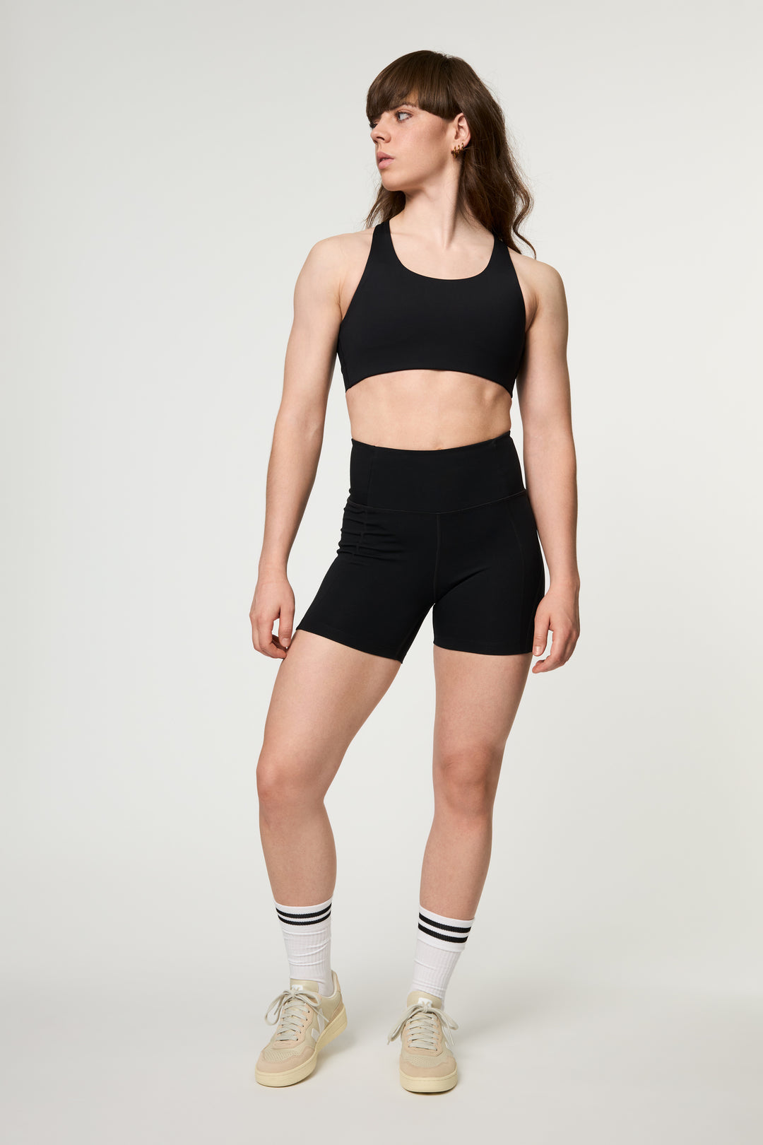 Front view of Girlfriend Collective high rise running shorts in black