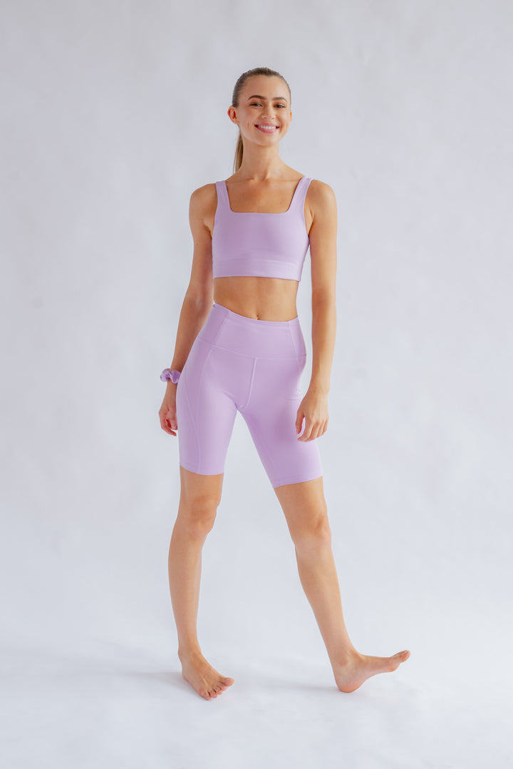 Front view of Girlfriend Collective high-rise bike shorts in Lilac