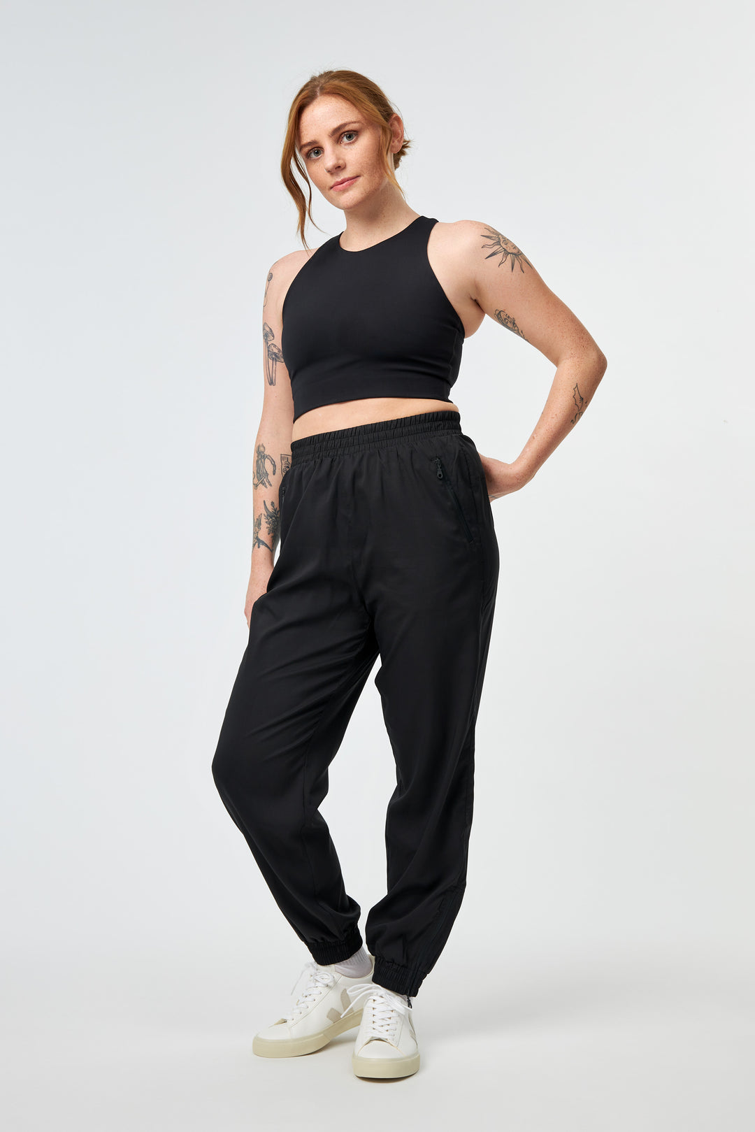 Model wearing Girlfriend Collective Dylan Bra in Black with joggers