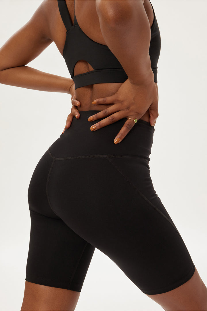 Back view of Girlfriend Collective bike shorts in black featuring hidden pocket and smooth high-rise support