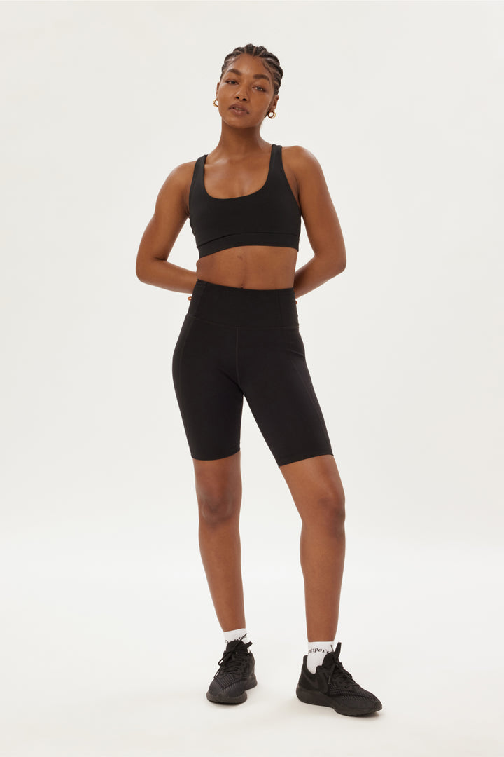 Front view of Girlfriend Collective high-rise bike shorts in black, showing sculpting fit and high waistband