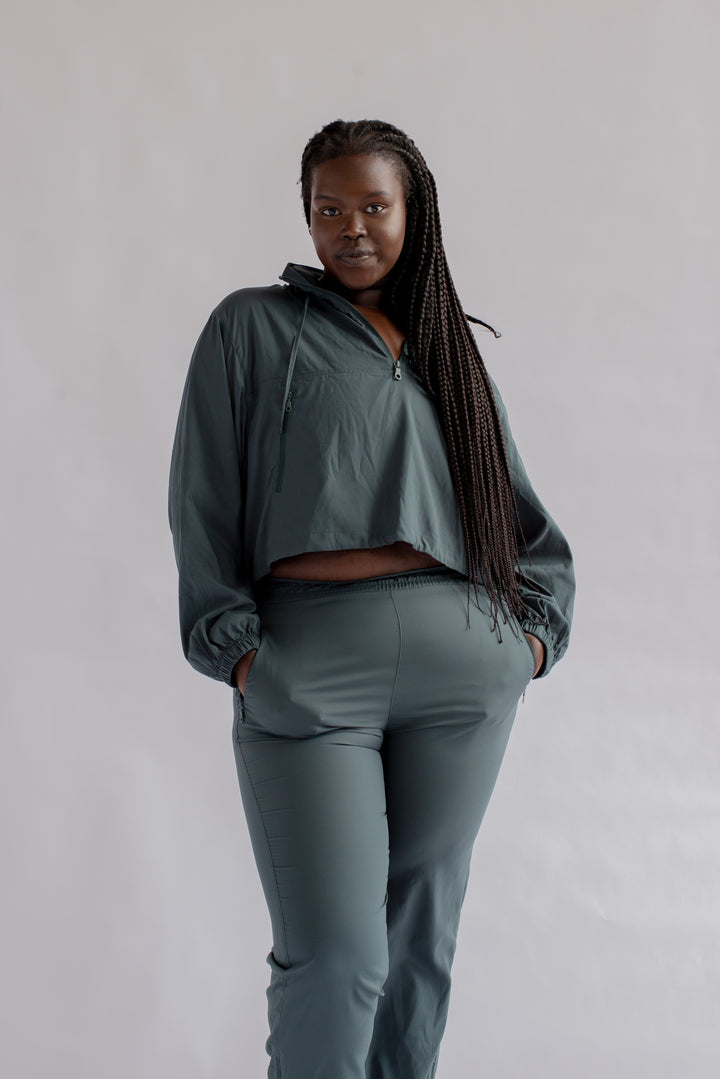 Close up of Girlfriend Collective Summit Track Pants in Moss with side pocket detail
