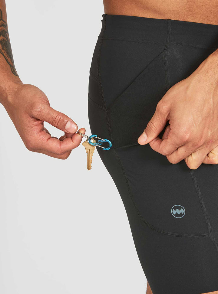 Interior key clip attachment on Janji half tights for men – secure storage detail view
