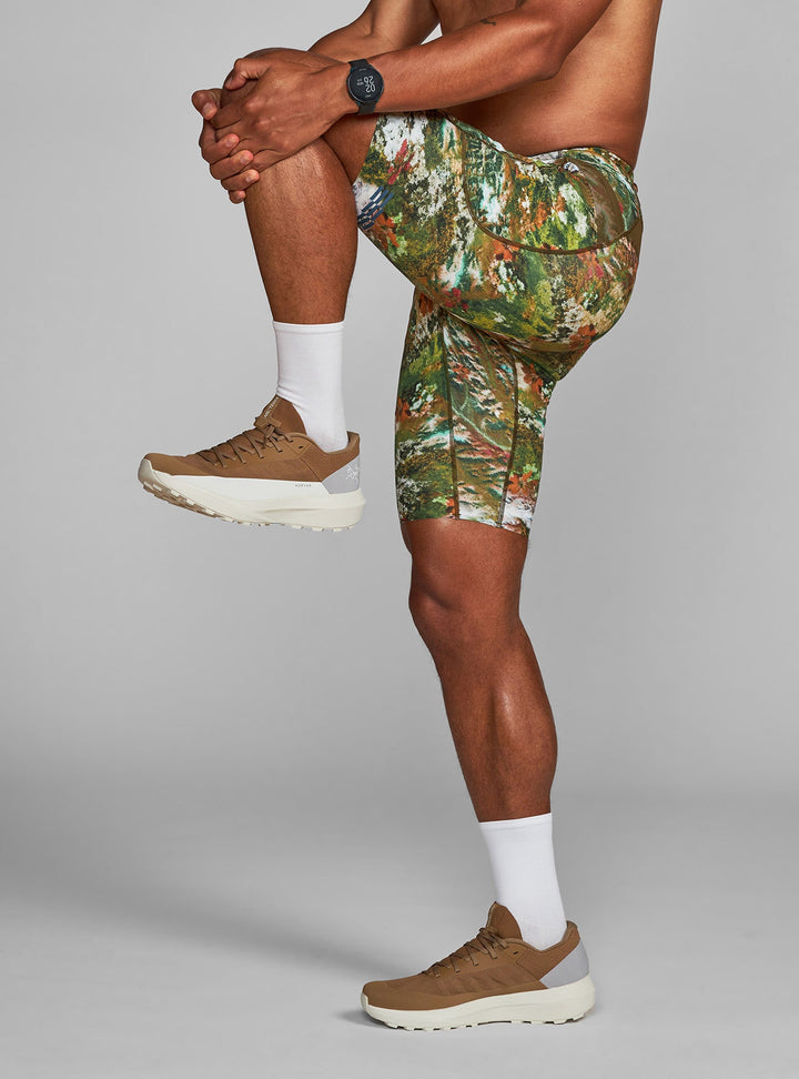 Janji half tights in Lichen Camo, model stretching; smooth, seamless hem close-up