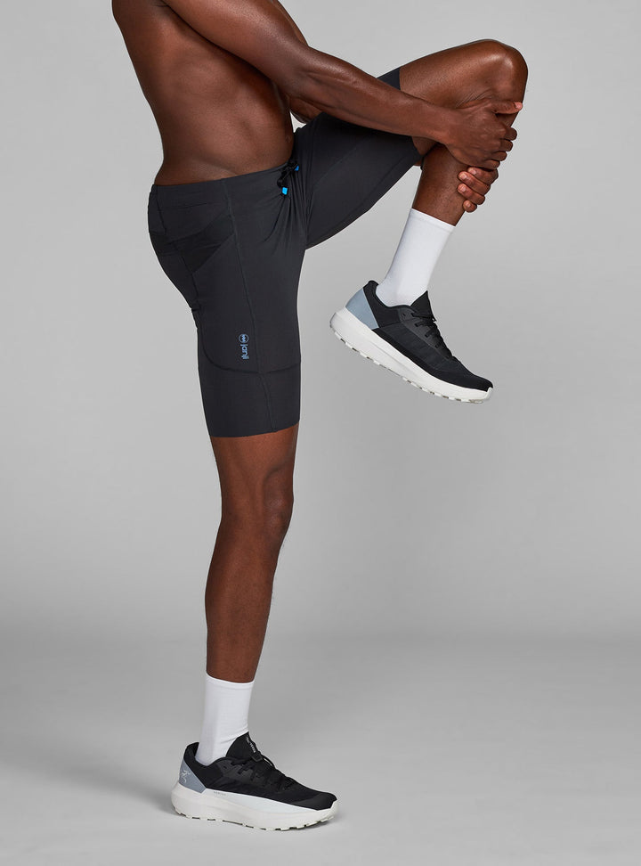Half tights for men in Midnight, model stretching showing smooth and seamless hem