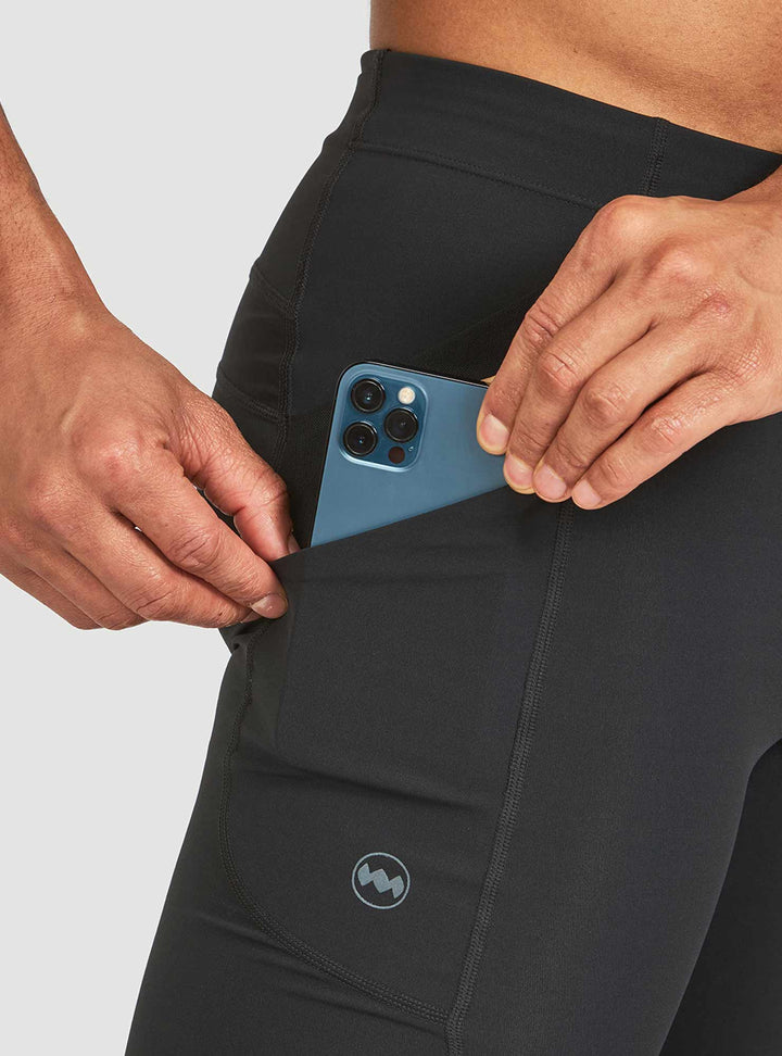 Side stash pocket on Janji 8-inch trail half tights holding a cellphone securely during run