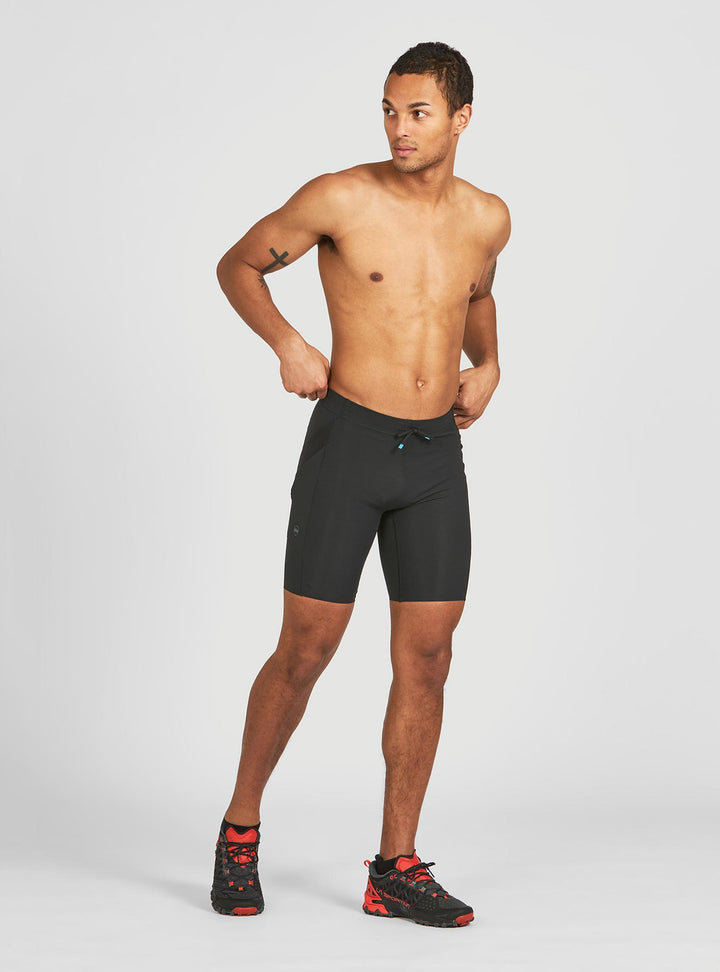 Janji 8 inch trail half tights for men – angled front view with compressive fit
