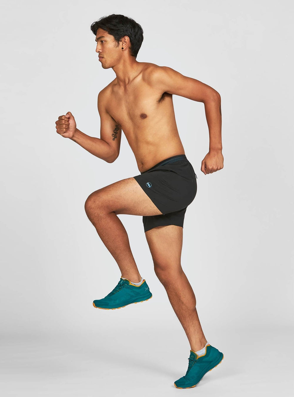Man running wearing Janji AFO Middle Shorts – lightweight and breathable
