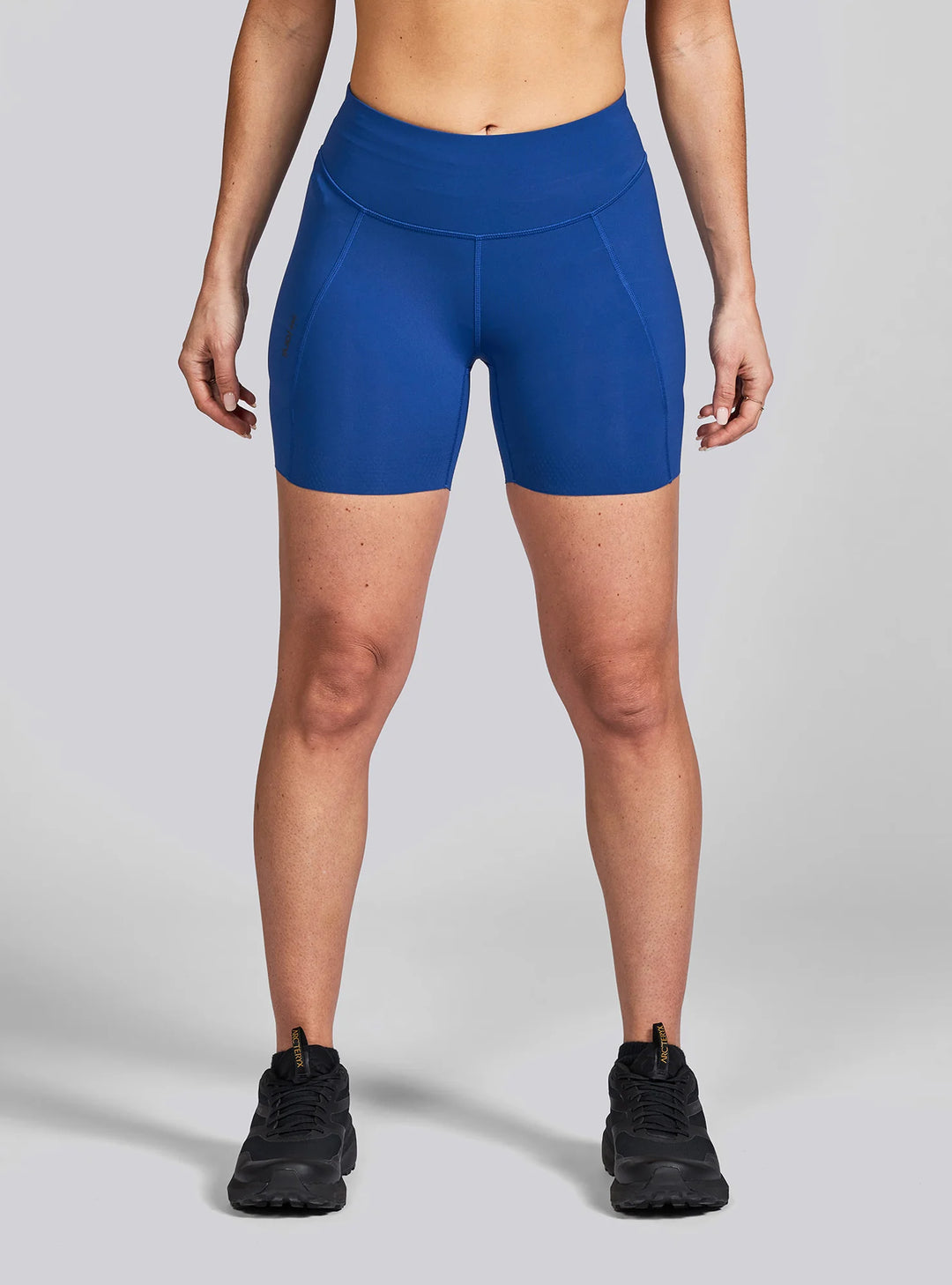 Front view of Janji Women’s 5" Pace Shorts in Sapphire showing lightweight, bike-length fit.