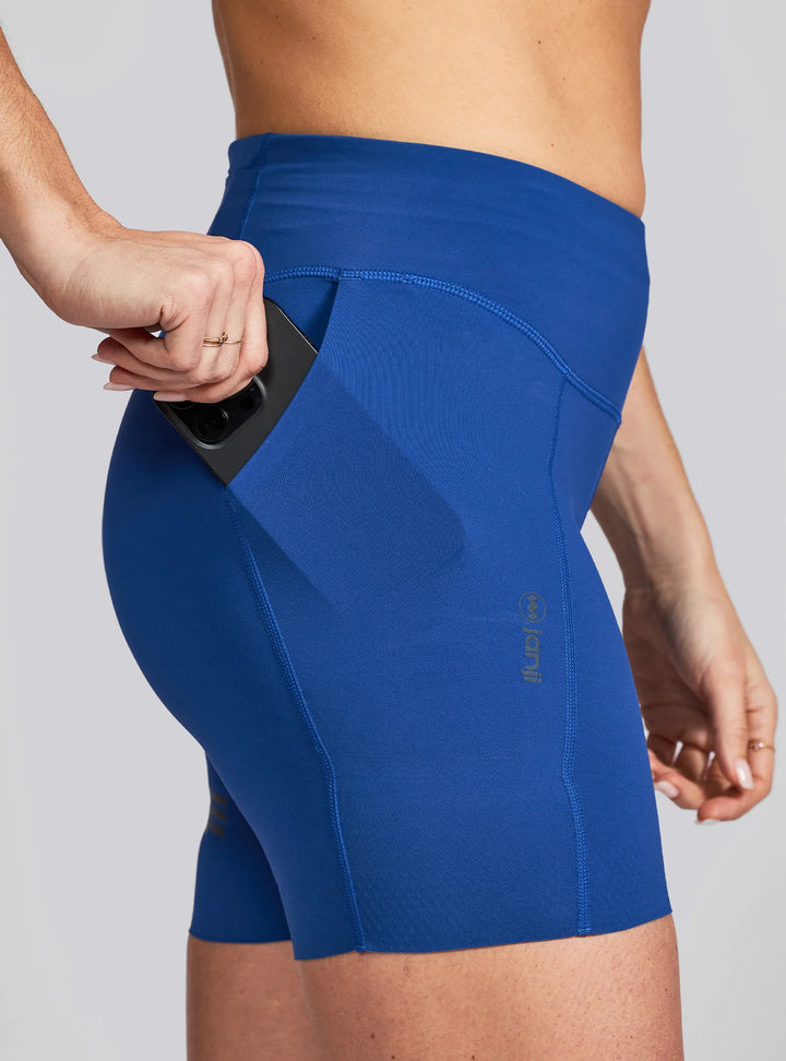 Close-up of deep side pocket on Janji 5" running shorts fitting a large smartphone with case
