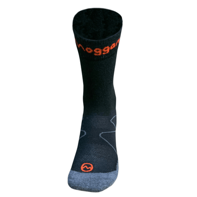 Moggans Merino Crew Socks Black finishing 4” above the ankle. Front view. Grey toe and heel, flat seams. Written Moggans logo in orange front of ankle. Small orange Moggans logo top centre front of sock. Thin linear mountain graphic outside midfoot area of sock in grey.